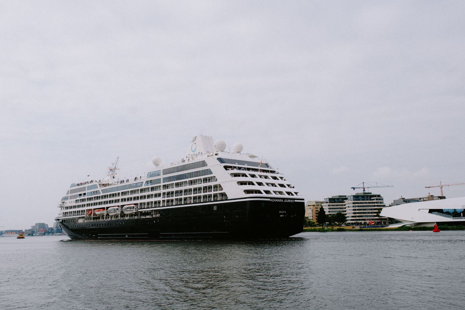 A cruise ship berthed at a city harbour terminal