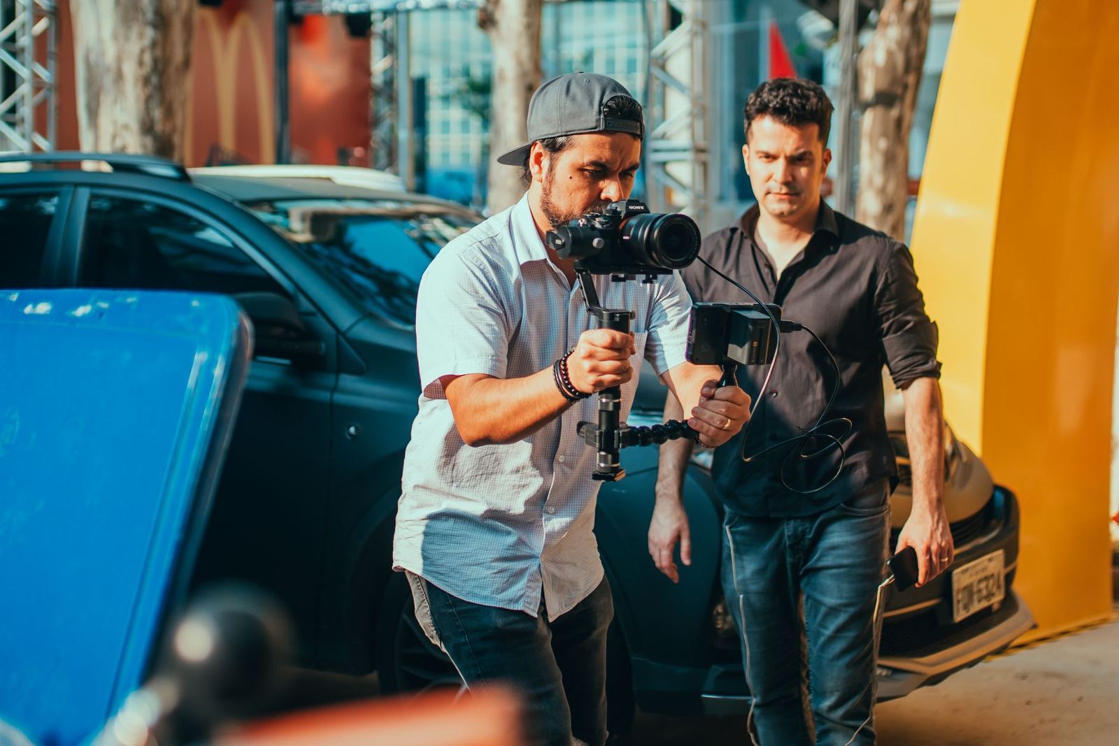 A camera operator and crew working on a film shoot